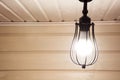 A vintage black lamp under the ceiling in a wooden farmhouse. Royalty Free Stock Photo