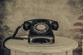 Vintage black phone on old walls background Royalty Free Stock Photo