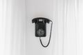 Vintage Black Rotary Phone hanging on Wall Royalty Free Stock Photo