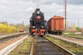 Vintage black steam locomotive train with wagons on station. Royalty Free Stock Photo