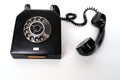 Vintage black telephone set with dialing dial in retro style on white background, concept of old communication technologies, call Royalty Free Stock Photo