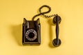 Vintage black telephone on yellow Royalty Free Stock Photo