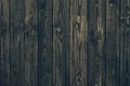 Vintage black vertical wood planks. Brown wooden grunge timber boards. Dark wooden panel texture. Dirty fence, carpentry hardwood. Royalty Free Stock Photo