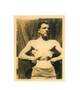Vintage black and white photo of bare chested man doing a body building pose 1940s to 1950s military - Social History
