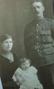 Vintage black and white photo of a family portrait with man in uniform possibly World War 1900s.