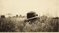 Vintage Black-and-white Photo: Hat In Tall Grass