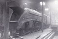 Vintage black and white photo of steam locomotive engine number 60012 in workshop / shed for repairs 1950s