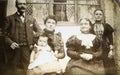 Vintage black and white photo of a Victorian family in front of house 1880s - 1900s. Royalty Free Stock Photo