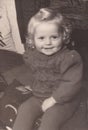 Vintage black and white photo of a young child smiling 1940s?