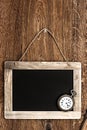 Vintage blackboard hanging on wooden wall Royalty Free Stock Photo