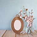 Vintage blank frame next to white spring flowers. selective focus. template, ready to put photography Royalty Free Stock Photo