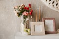 Vintage blank wooden frames and rose in a vase on a white shelf Royalty Free Stock Photo