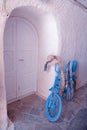 Vintage blue bike with white door, Greece Royalty Free Stock Photo