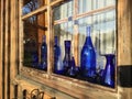 Vintage Blue Bottles In Wooden Window