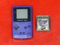 Vintage blue Game Boy with Super Mario Bros game