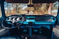 Vintage blue hippie Volkswagen van interior with the outside landscape