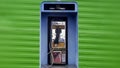 Vintage Blue outdoors public payphone booth green backdrop