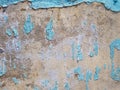 Vintage blue paint peeling off uneven rough texture wall with cement grain and rustic copyspace background Royalty Free Stock Photo