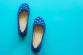 Vintage blue pair of polka dot shoes on a blue background Royalty Free Stock Photo