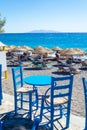 Blue table and two chairs by Black Beach Kamari Santorini Greece Royalty Free Stock Photo