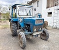 Vintage blue tractor on farm with weathered exterior and rustic charm Royalty Free Stock Photo