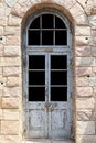 Vintage blue wood door ,Building entrance and brown stone wall Royalty Free Stock Photo