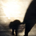 Vintage blurry shadow of a boy and an adult walking
