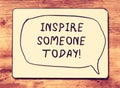 Vintage board with the phrase inspire someone today! written on it. retro filtered image
