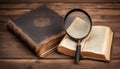 Vintage book and magnifying glass on wooden background