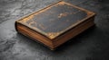 Vintage Book with Worn Leather Cover and Gold Edging on a Dark Surface Royalty Free Stock Photo