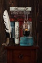 Vintage books, old oil lamp and antique inkwell with a feather Royalty Free Stock Photo