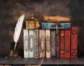 Vintage books, ancient caskets, manuscript and antiquarian inkwell with a feather Royalty Free Stock Photo