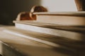 Vintage books on wooden shelf with daylight