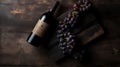 Vintage bottle of red wine with blank matte black label, bunch of grapes on wooden table, concrete wall background. Expensive Royalty Free Stock Photo