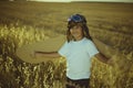 Vintage, Boy playing to be airplane pilot, funny guy with aviator cap and glasses, carries wings made of brown cardboard as an ai Royalty Free Stock Photo