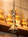 a vintage brass bell with lord ganesh dancing statue hanging on a chain Royalty Free Stock Photo