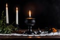 Vintage brass candelabra of five burning candles with dripping wax on a black background vertical background. photo