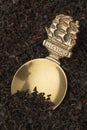 Vintage brass English Tea caddy spoon in dried Java Melange tea leaves Royalty Free Stock Photo
