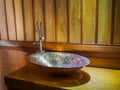 Vintage brass wash basin in wooden bathroom. Royalty Free Stock Photo