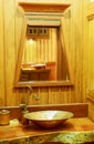 Vintage brass wash basin in wooden bathroom. Royalty Free Stock Photo