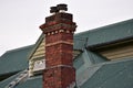 Vintage brick chimney on metal roof Royalty Free Stock Photo