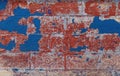 Vintage brick wall background. Brick texture with several layers of peeled paint. Old crumbling wall. Royalty Free Stock Photo