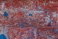 Vintage brick wall background. Brick texture with several layers of peeled paint. Old crumbling wall. Royalty Free Stock Photo