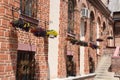 Vintage brick wall building with flowers at windows