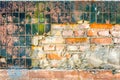 Vintage brick wall, cement and plaster, old broken glossy black ceramic tiles