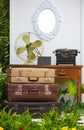 Vintage briefcase and fan in a garden setting