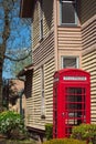 Vintage red phone booth by an old house in an Ohio village Royalty Free Stock Photo