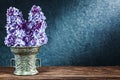Vintage bronze bowl with flowers of lilac on black background with copyspace Royalty Free Stock Photo