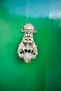 Vintage bronze door handle on old maltese green wooden door, Valletta, Malta