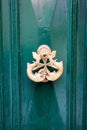 Vintage bronze door handle on old maltese green wooden door, Valletta, Malta